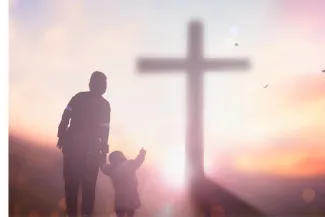 Mother and child pointing to the cross