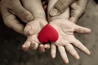 Adult holding a child’s hands