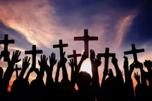 Raised hands holding crosses